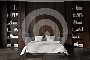 Dark bedroom interior with bed and decoration on shelf. Empty wall