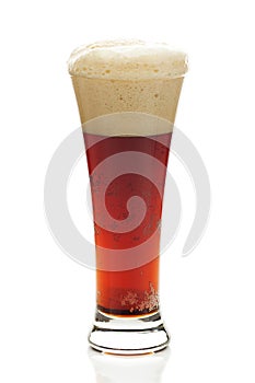 Dark beer with the foam in a tall glass
