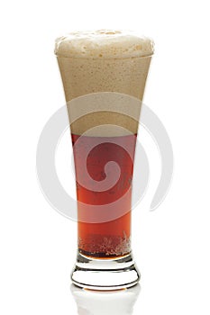 Dark beer with the foam in a tall glass