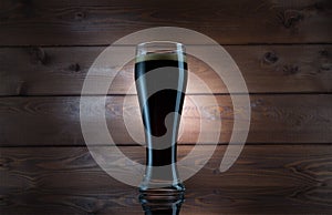 Dark Beer in Glass over Wooden Background. Isolated Mug Full of Fresh Beer