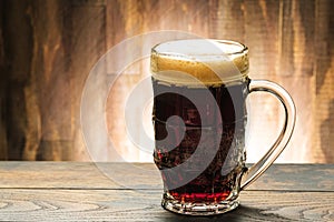 Dark beer in glass on table in pub with copy space