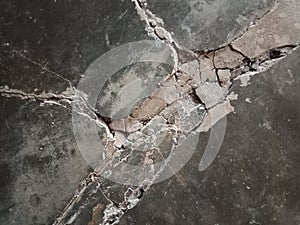 The dark black floor is damaged with a cement texture, taken during the day