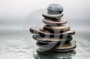 Dark or black rocks on water, background for spa, relax or wellness therapy photo