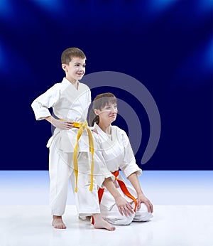 On a dark blue background Mother and son in karategi