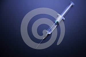 On dark blue background syringes. The concept of medicine and drug addiction