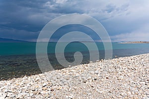 Dark blue clouds and sea or ocean water surface with dramatic seascape