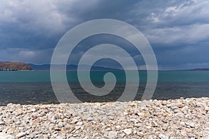 Dark blue clouds and sea or ocean water surface with dramatic seascape