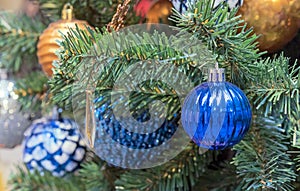 Dark blue faceted Christmas ball on Christmas tree. Christmas decor.