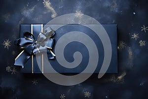 Dark blue gift box with elegant ribbon on dark background. Top view of Greeting gift with copy space for Christmas present,