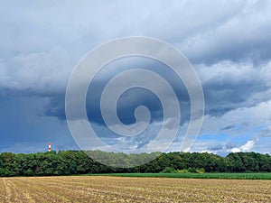 dark blue and gray clouds over green forest. Slovenia