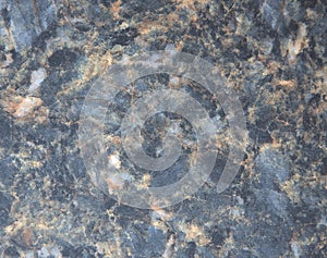 Dark blue marble, polished surface of natural stone with multi-colored splashes and veins close-up