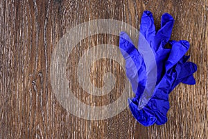 Dark blue nitrile exam gloves on a rustic wood table photo