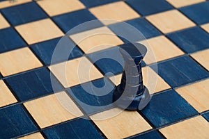 Dark blue rook on wooden chessboard