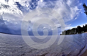 Dark blue sky over the lake before the storm, fish-eye