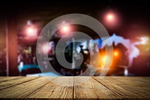 Dark blurred background of bar restaurant and old brown wooden table top with space for advertising product.