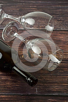 Dark bottle of wine and glasses on wooden background. Top view