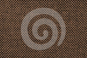 Dark brown background of dense woven bagging fabric, closeup. Structure of the textile macro.