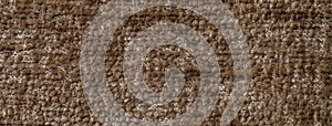 Dark brown fluffy background of soft, fleecy cloth. Texture of umber textile fabric backdrop