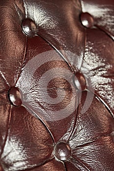 Dark brown leather background, close-up, shallow depth of field