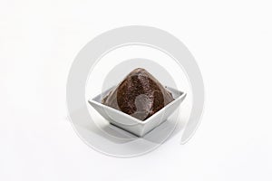Dark brown miso paste isolated on white background. Traditional Japanese seasoning, indispensable ingredient for cooking soup photo