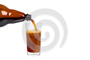 Dark brown plastic bottle of beer or kvass with glass cup isolated on a white background, copy space template.