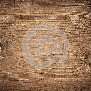 Dark brown scratched wooden cutting board. Wood