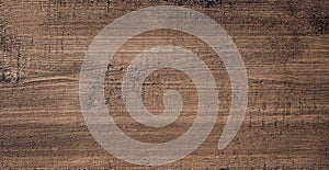 Dark brown scratched wooden cutting board. Wood texture photo