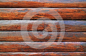 Dark brown wood log wall of an aging log cabin for texture, background