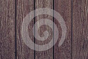 Dark brown wood texture background. Dark brown wooden fence. Dark wooden boards close-up. Pattern on dark wood backdrop.  Wood bro