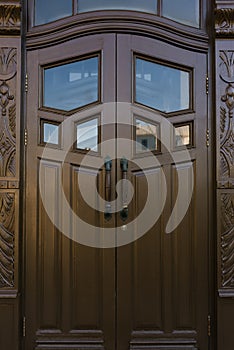 Dark brown wooden doors with carving