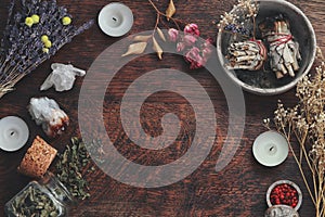 Dark brown wooden table background for text, decorated with witchy wiccan items to look esoteric and occult