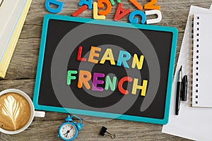 Dark chalkboard with Learn French advice from colourful plastic letters