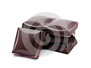 Dark chocolate bars stack with crumbs isolated