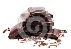 Dark chocolate bars stack with crumbs isolated on a white