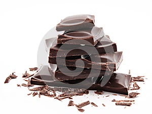 Dark chocolate bars stack with crumbs isolated on a white