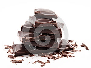 Dark chocolate bars stack with crumbs isolated on a white