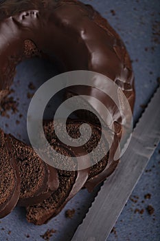 Dark chocolate cake covered with icing covered on a dark background. Selective focus.