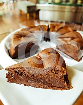 Dark chocolate cake on white plate