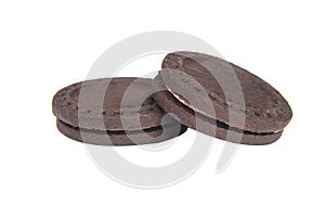 Dark chocolate cookies twist sandwich with cream filling isolated on the white background