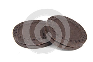 Dark chocolate cookies twist sandwich with cream filling isolated on the white background