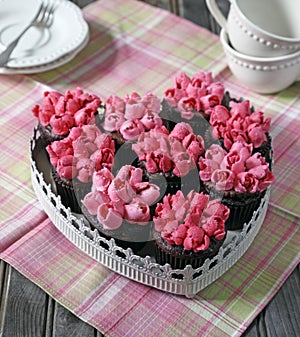 Dark chocolate cupcakes decorated with pink tulips