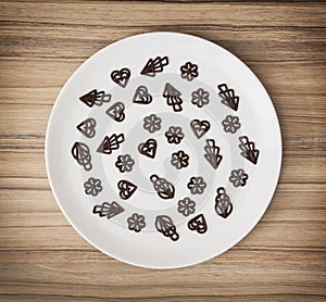 Dark chocolate garnishes in the big plate, symbolic food