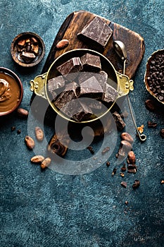 Dark chocolate pieces crushed and cocoa beans. Chocolate background