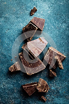 Dark chocolate pieces crushed on a dark background