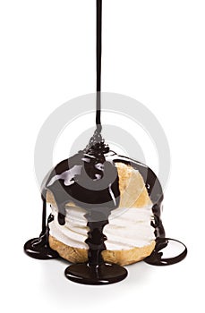 Dark Chocolate Syrup Pours Over Creampuff or Profiterole