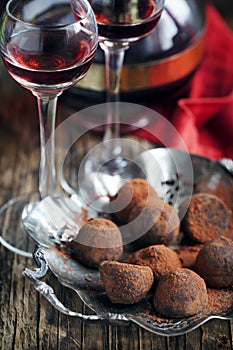 Dark chocolate truffles and two glasses of raspberry liqueur