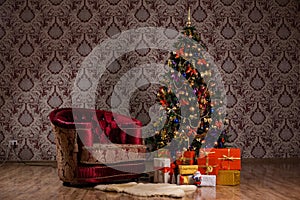 Dark Christmas scene with a decorated Christmas tree, gifts and armchair