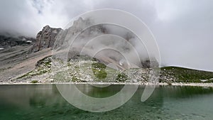 Dark cloud over Pilato lake at the feet of Mount Redentore