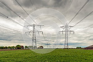 Dark clouds above the power lines and pylons