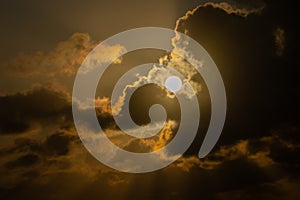 Dark clouds back-lit by rising sun